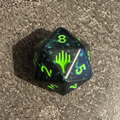 Dé D20 Spindown noir et vert d'avant-première, symbole Magic