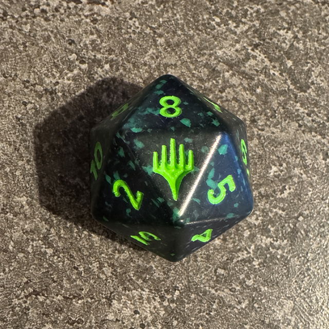 Dé D20 Spindown noir et vert d'avant-première, symbole Magic